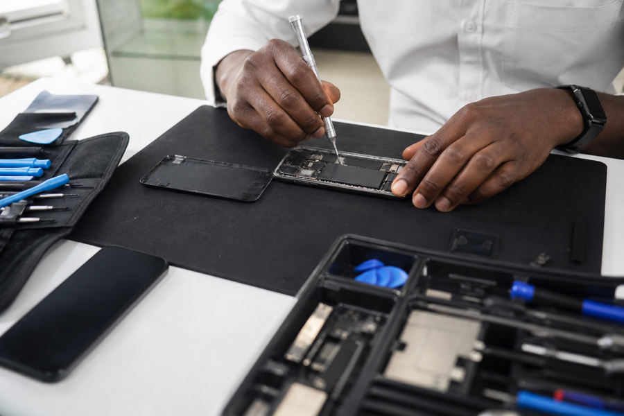 Technician repairing an open smartphone on the bench